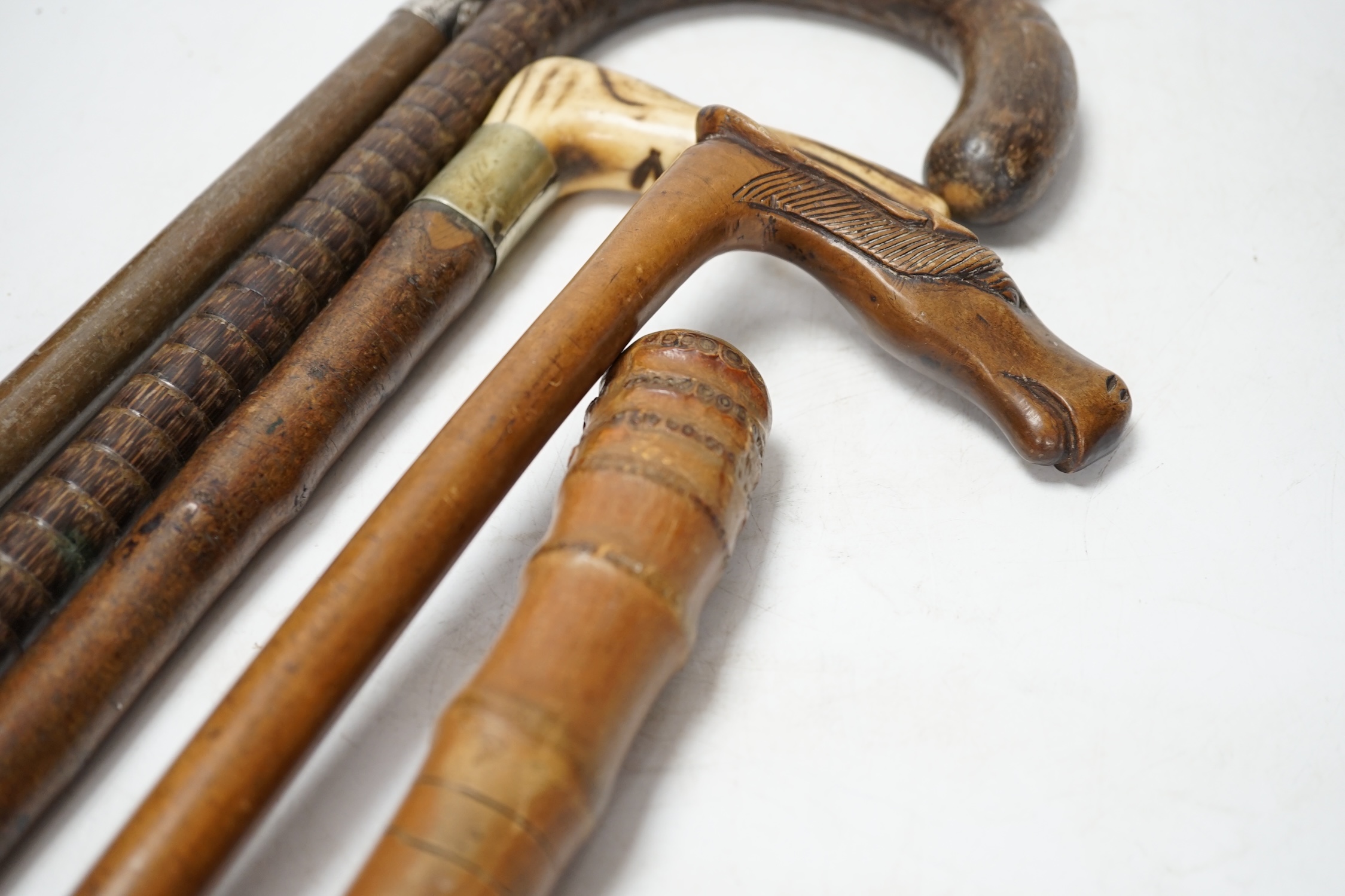 A collection of five various walking sticks/canes including silver mounted, longest 93cm. Condition fair